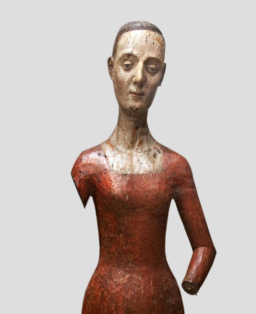 Wooden effigy of Catherine de Valois, in red dress, right arm and left hand missing