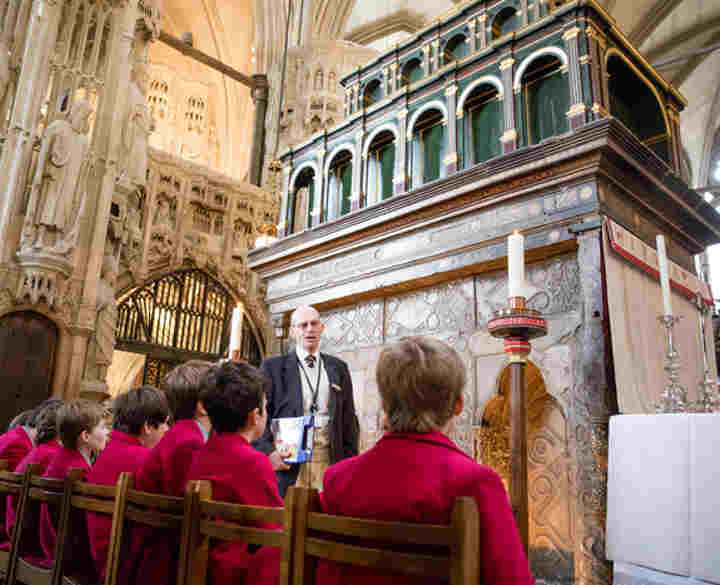 A group of secondary school students sat in front of the Shrine of St Edward the Confessor