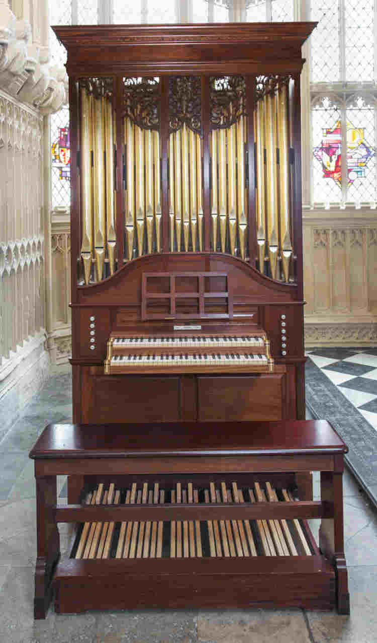 Small pipe organ of red wood with gold pipes and decorated carving in the Lady Chapel