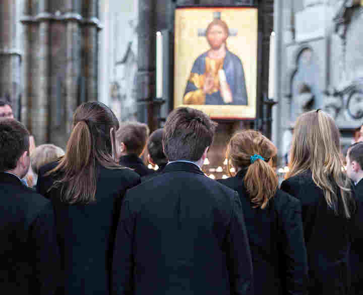 Secondary school students looking at an Icon painting of Christ in Westminster Abbey