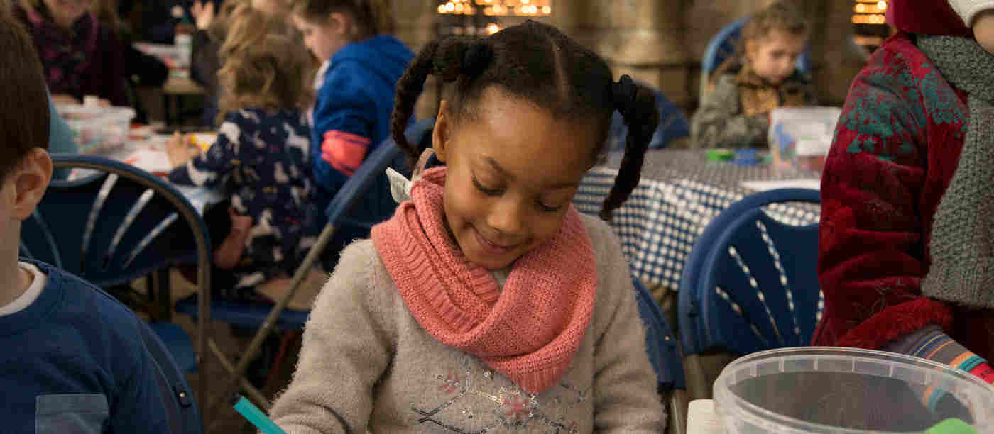 Photograph of young girl colouring in with felt tip pens, representing a Family Day activity at Westminster Abbey based on the Bayeux Tapestry as part of the Fraternite season