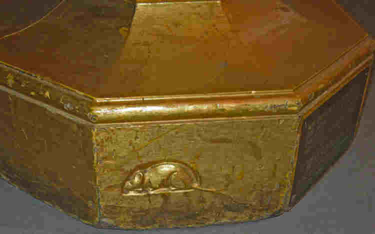 A mouse carved on the base of a candlestick