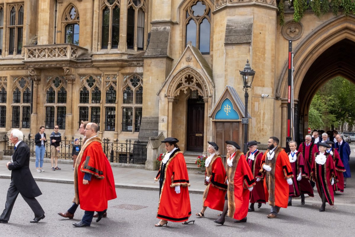 People dressed in red robes walking