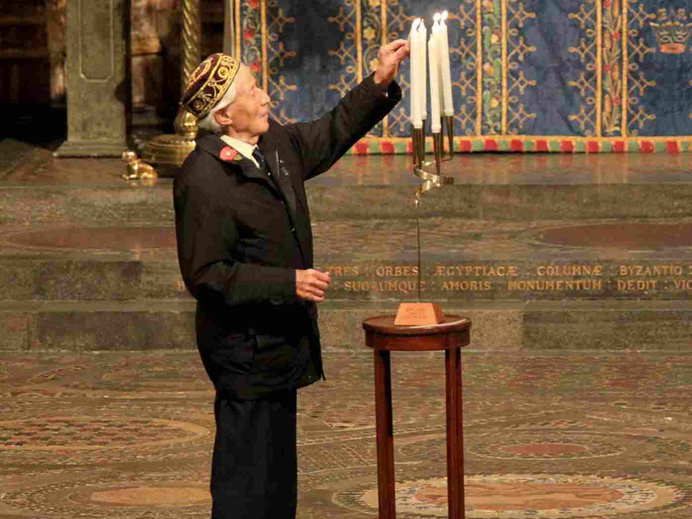 Rolf Penzias, survivor, lights a memorial candle
