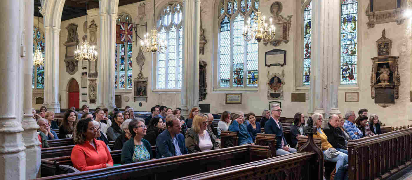 Photograph of members of the public sitting listening to a talk in St Margaret's Church at Westminster Abbey