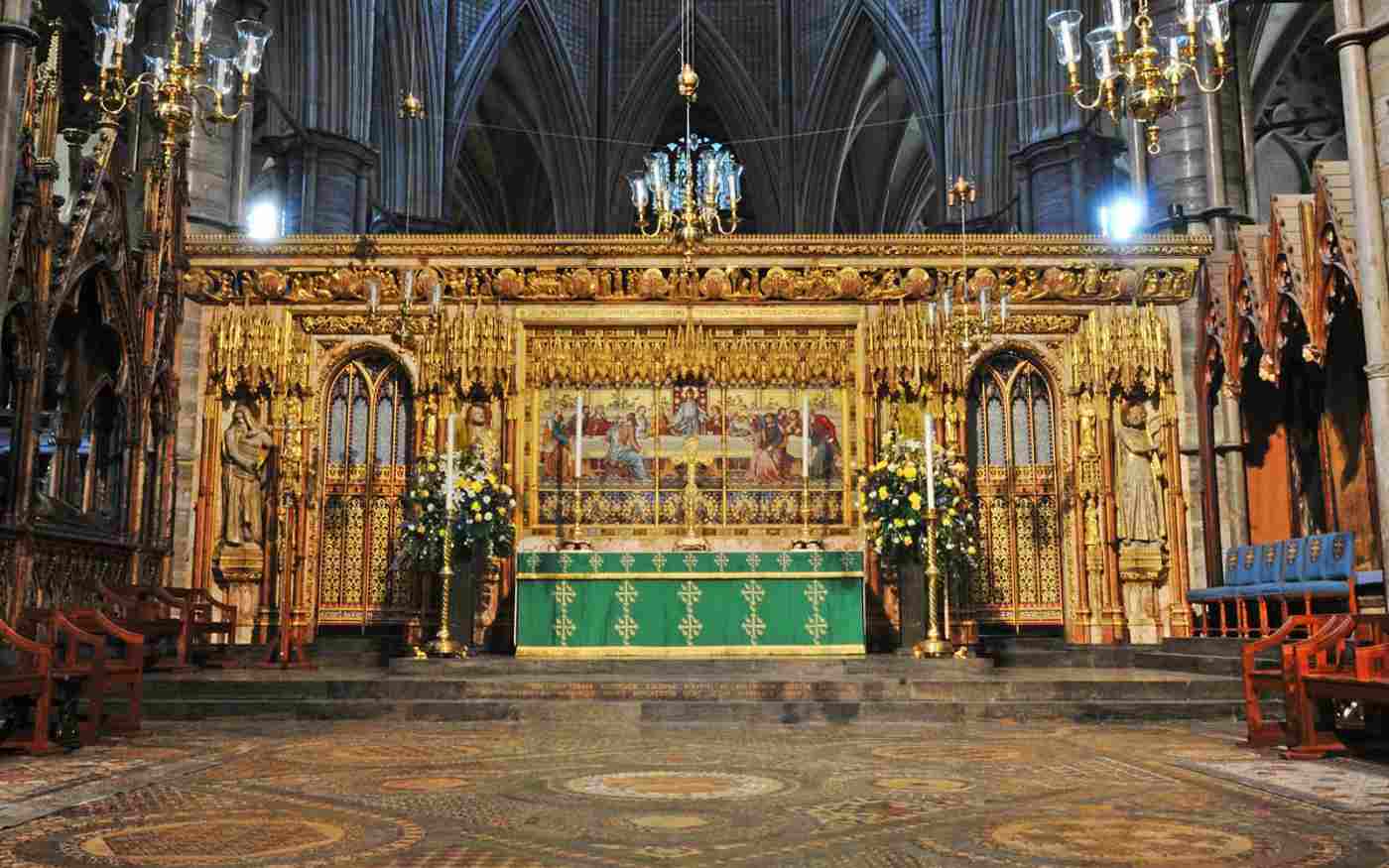 The high Altar on the Abbey. A gold-gilded panel is at the back and an altar and candlesticks appear in front.