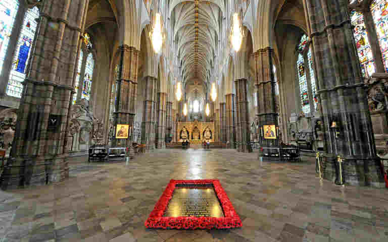 Photograph of the empty nave of Westminster Abbey, with the Grave of the Unknown Warrior surrounded by poppies in the forefront, representing the Abbey Highlights trail teachers notes