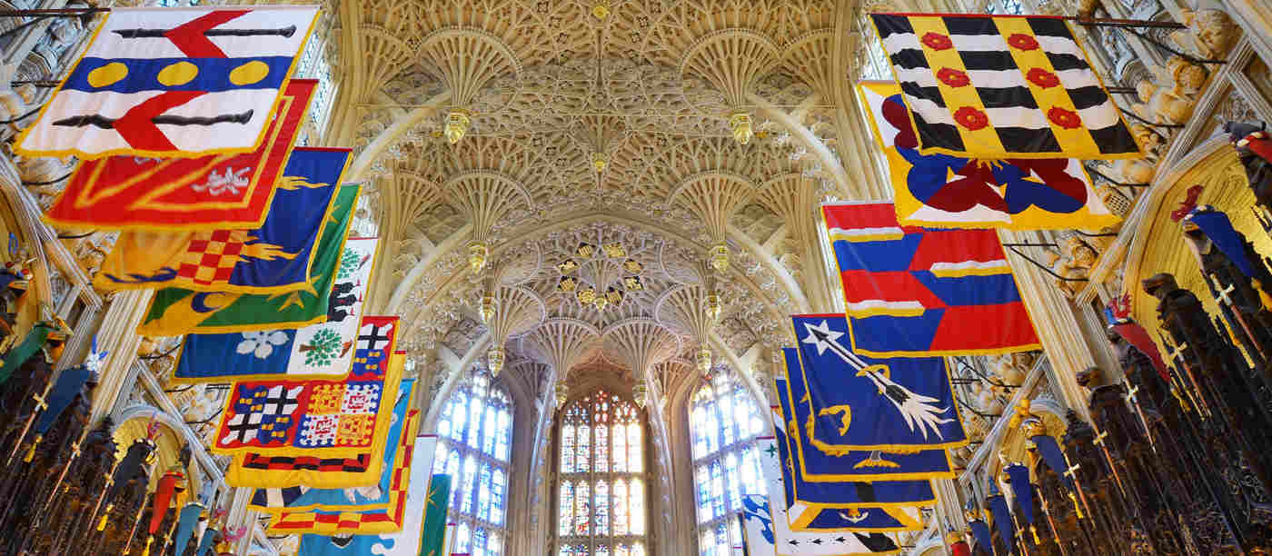 Photograph of the Lady Chapel ceiling with the colourful Order of the Bath flags for a talk by Nandini Das at Westminster Abbey