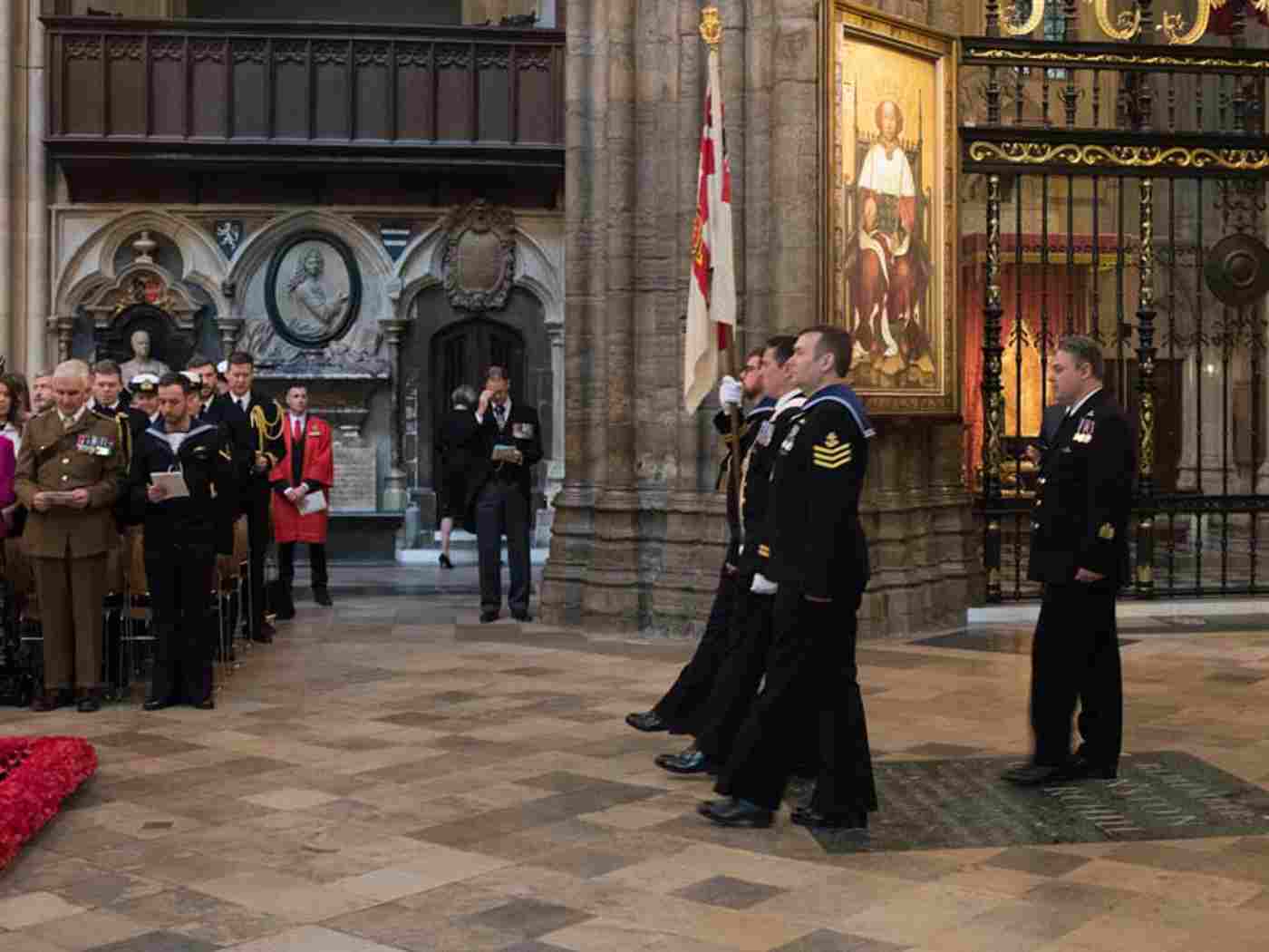 Lieutenant Gary Linden RN bears the Submarine Service Colour through the Abbey church