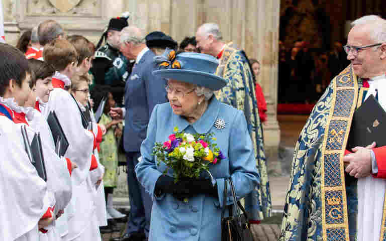 Queen Elizabeth II meeting choir boys whilst Dean David Hoyle accompanies her.