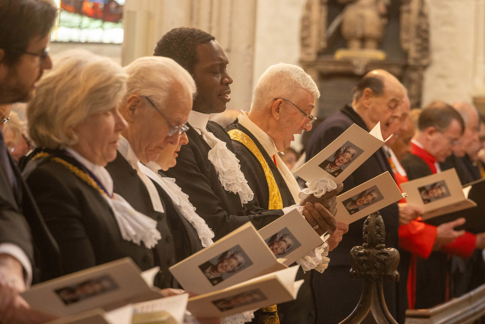 The congregation reading from orders of service