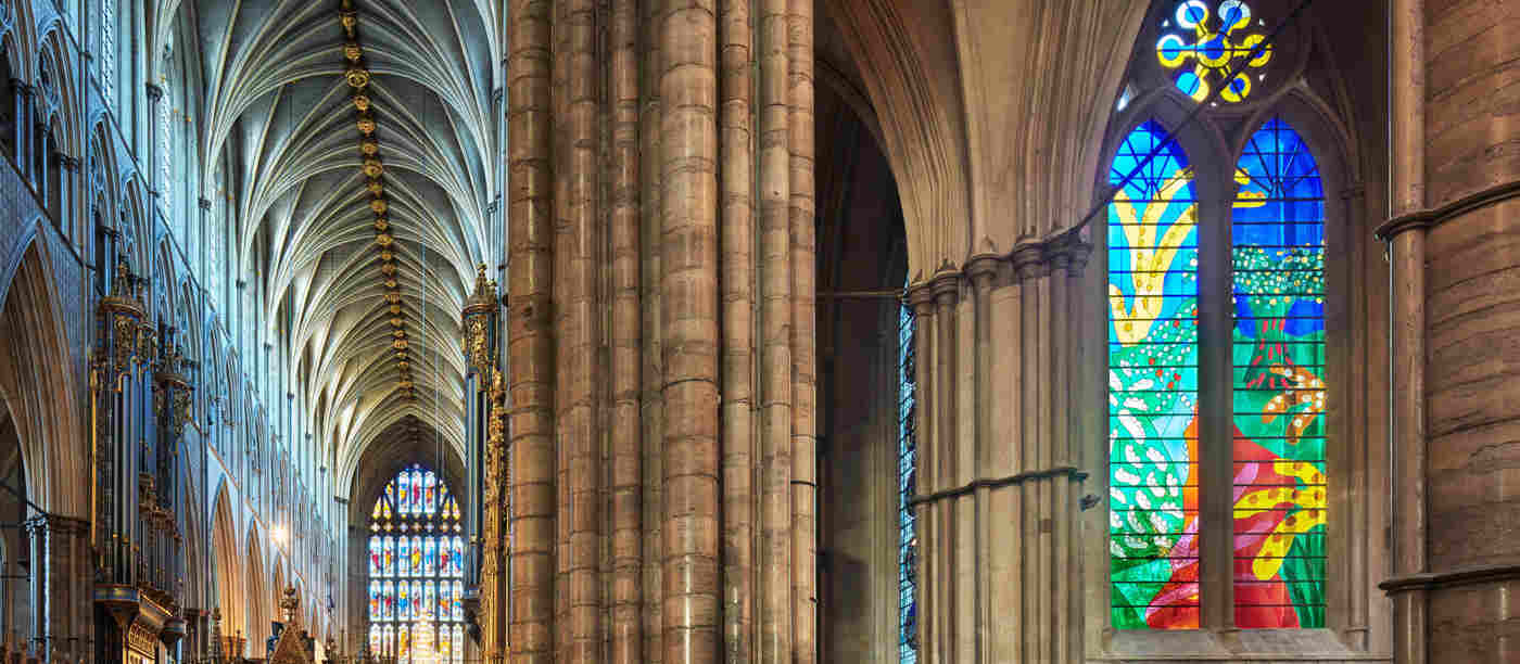 Photograph of stained glass window and gothic archtecture within the quire of Westminster Abbey