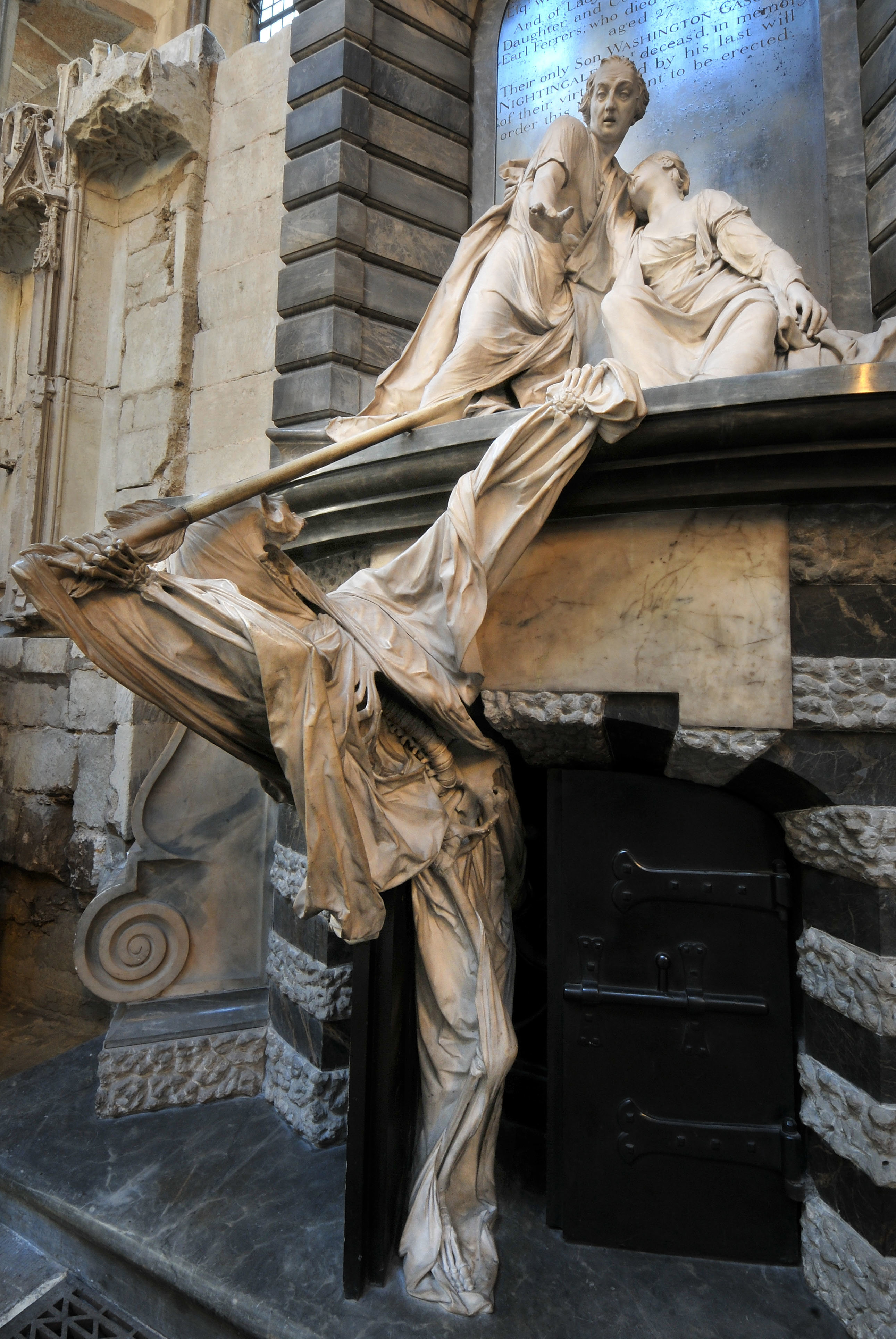 Marble figure of death emerging from a tomb