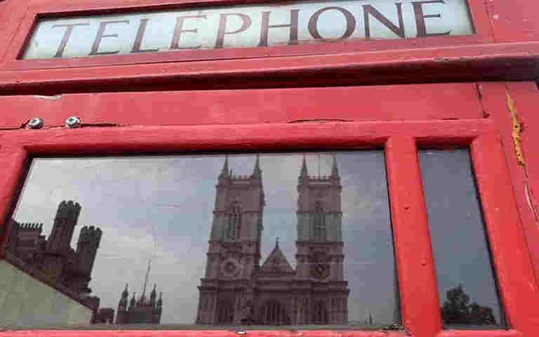 Photograph of Westminster Abbey reflected in a telephone box, representing the Lights, Camera, Action video about John Herschel