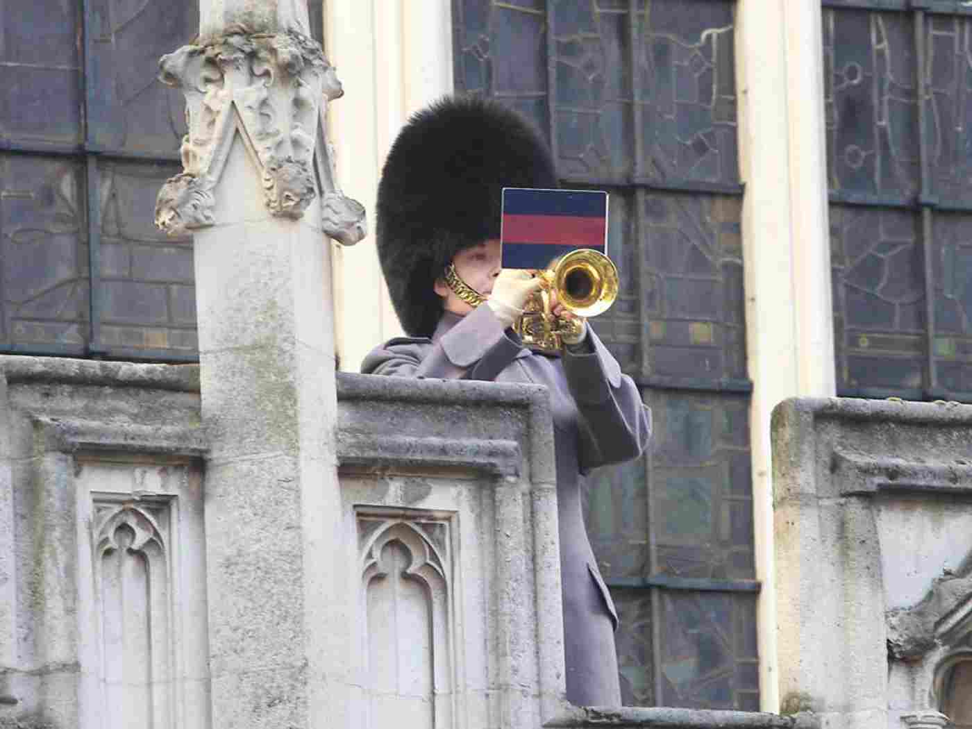 Last Post is sounded from the parapet of St Margaret's Church by a bandsman of the Scots Guards