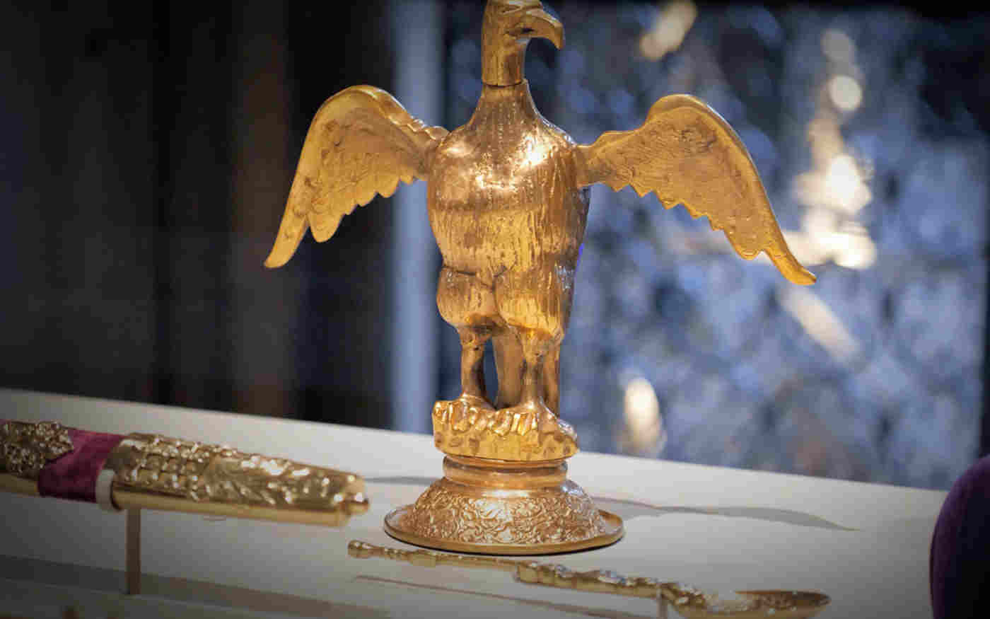 Photograph of replica ampulla, an eagle shaped container, and anointing spoon within the Queen's Diamond Jubilee Galleries at Westminster Abbey