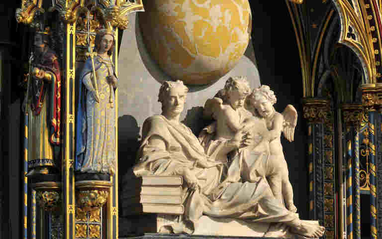 Photograph of Isaac Newton statue in Westminster Abbey, representing the Give it Up video