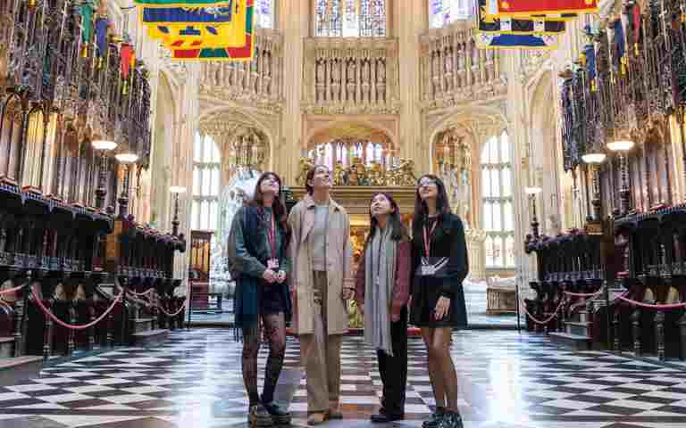 Photograph of four students standing looking up in the middle of the Lady Chapel of Westminster Abbey