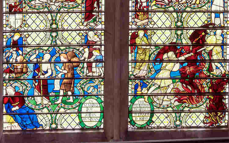 John Bunyan window with dreaming figure and fight with Apollyon