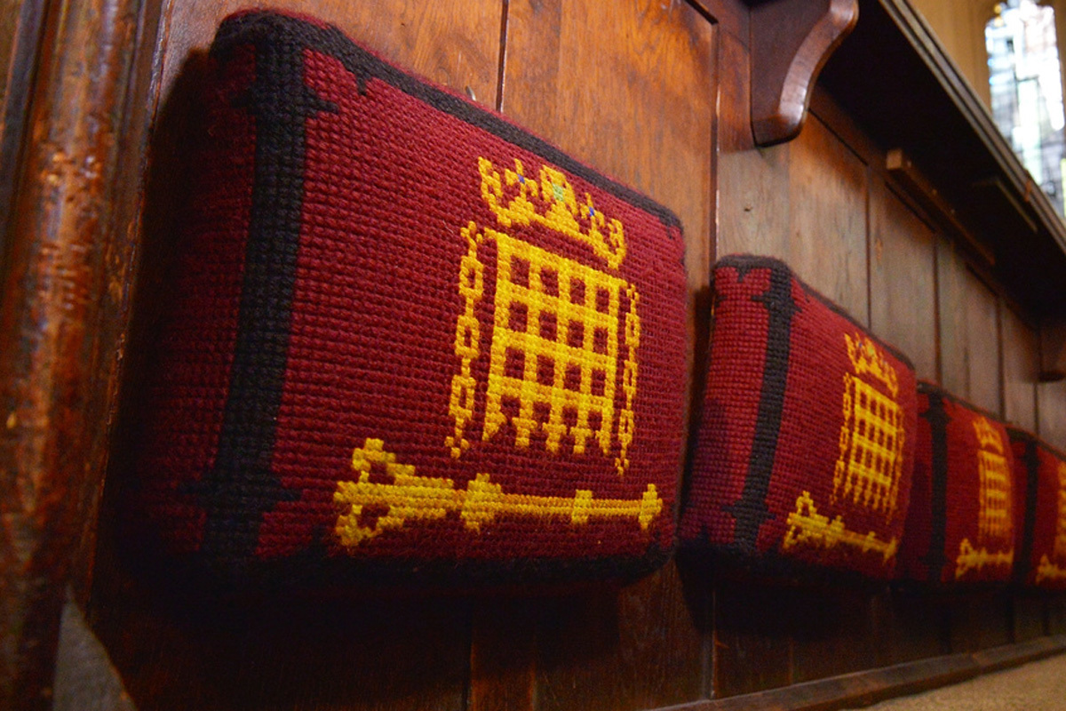 Red kneelers in St Margaret's Church with the portcullis symbol in yellow