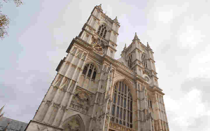 Photograph of the West Towers of Westminster Abbey with a grey clouded sky