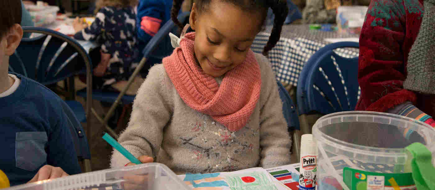 Photograph of young girl colouring in with felt tip pens, representing a Family Day activity at Westminster Abbey based on the Bayeux Tapestry as part of the Fraternite season