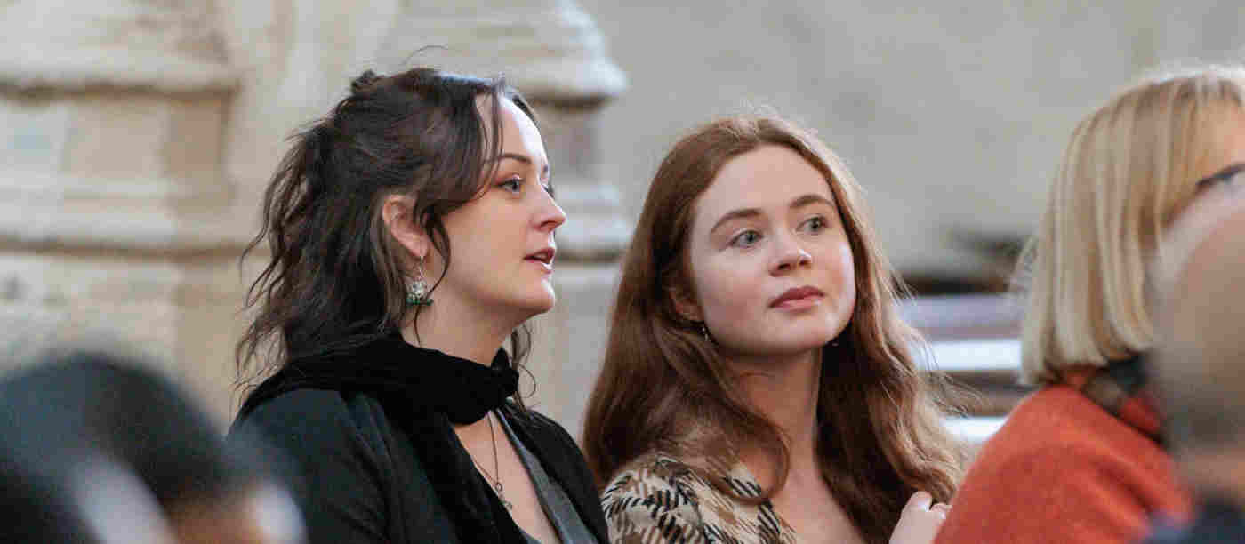 Photograph of two women sitting and listening to a talk within St Margaret's Church, Westminster Abbey