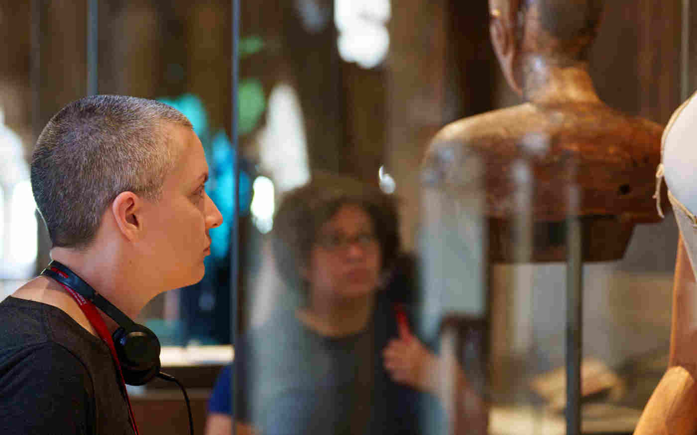 Photograph of member of the public looking at a glass case containing dressmaker's dummy within the Queen's Diamond Jubilee Galleries at Westminster Abbey