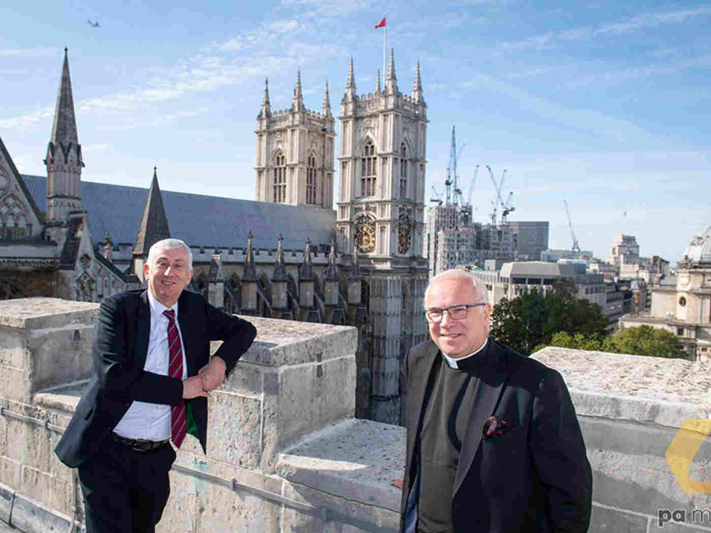 Sir Lindsay and Dr Hoyle on the roof of St Margaret's Church, with the Abbey behind