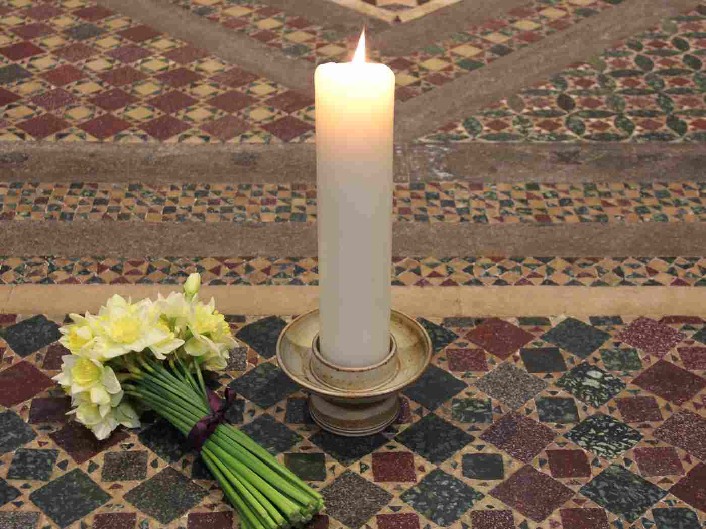 The flowers and candle left by Their Royal Highnesses during their visit