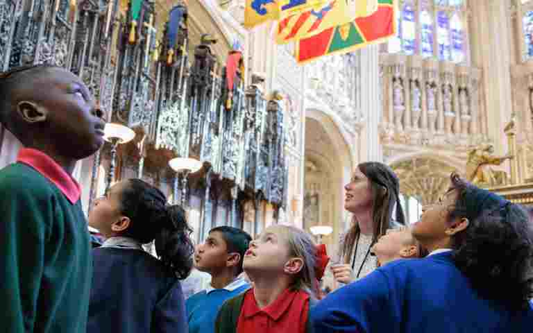Photograph of a group of primary school students looking up and around the Lady Chapel of Westminster Abbey