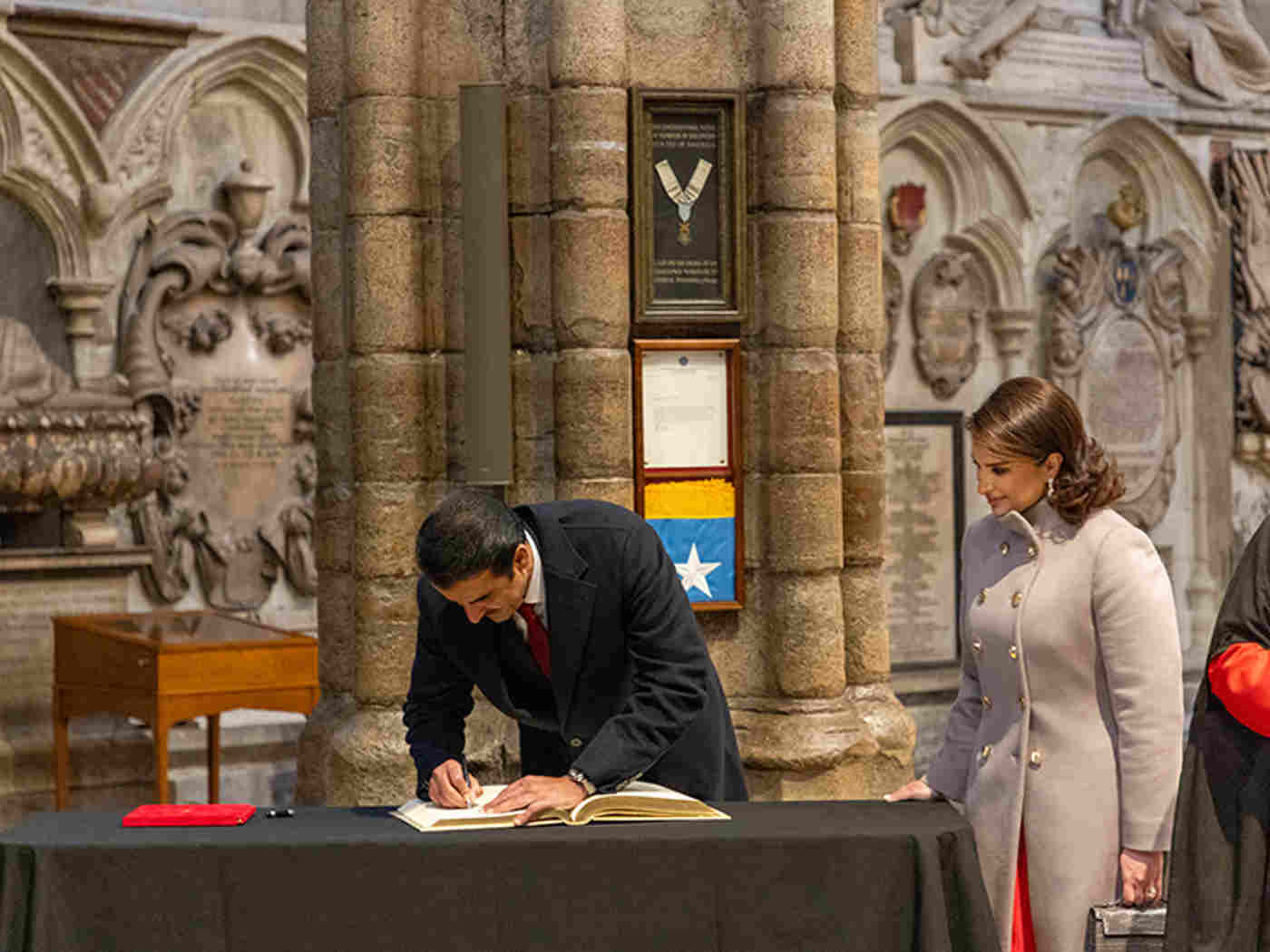 The Amir signs the Distinguished Visitors’ Book