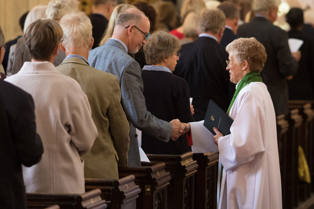 Canon Sinclair is congratulated by a member of the congregation
