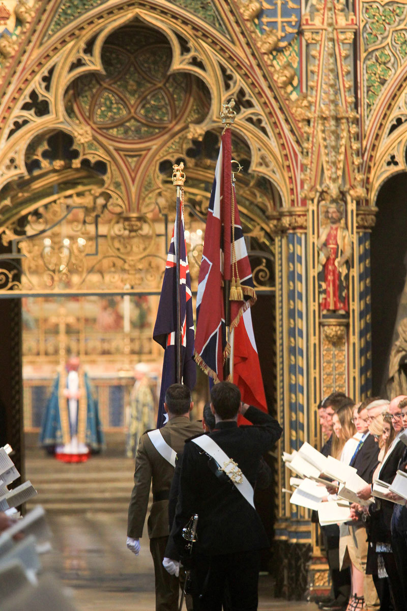 The flags of Australia, New Zealand, Turkey, and the United Kingdom are carried through the Abbey Church