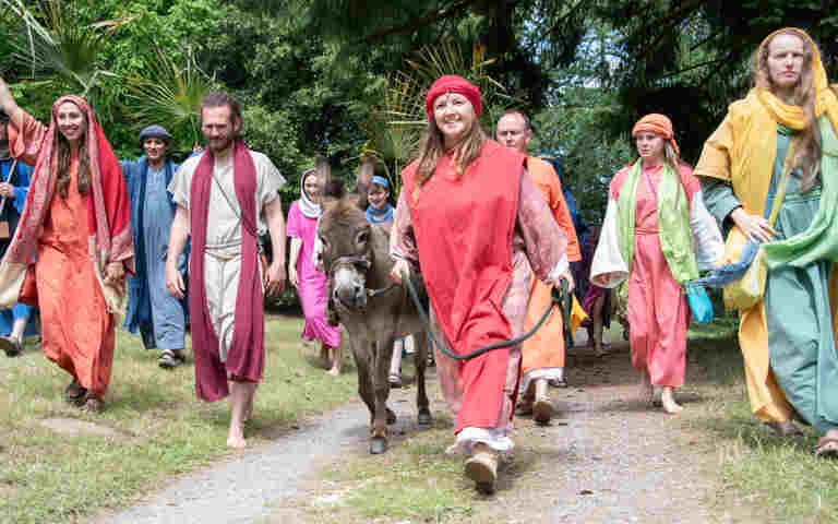 Photograph of Wintershall Education staff dressed up walking in an outside space including a donkey