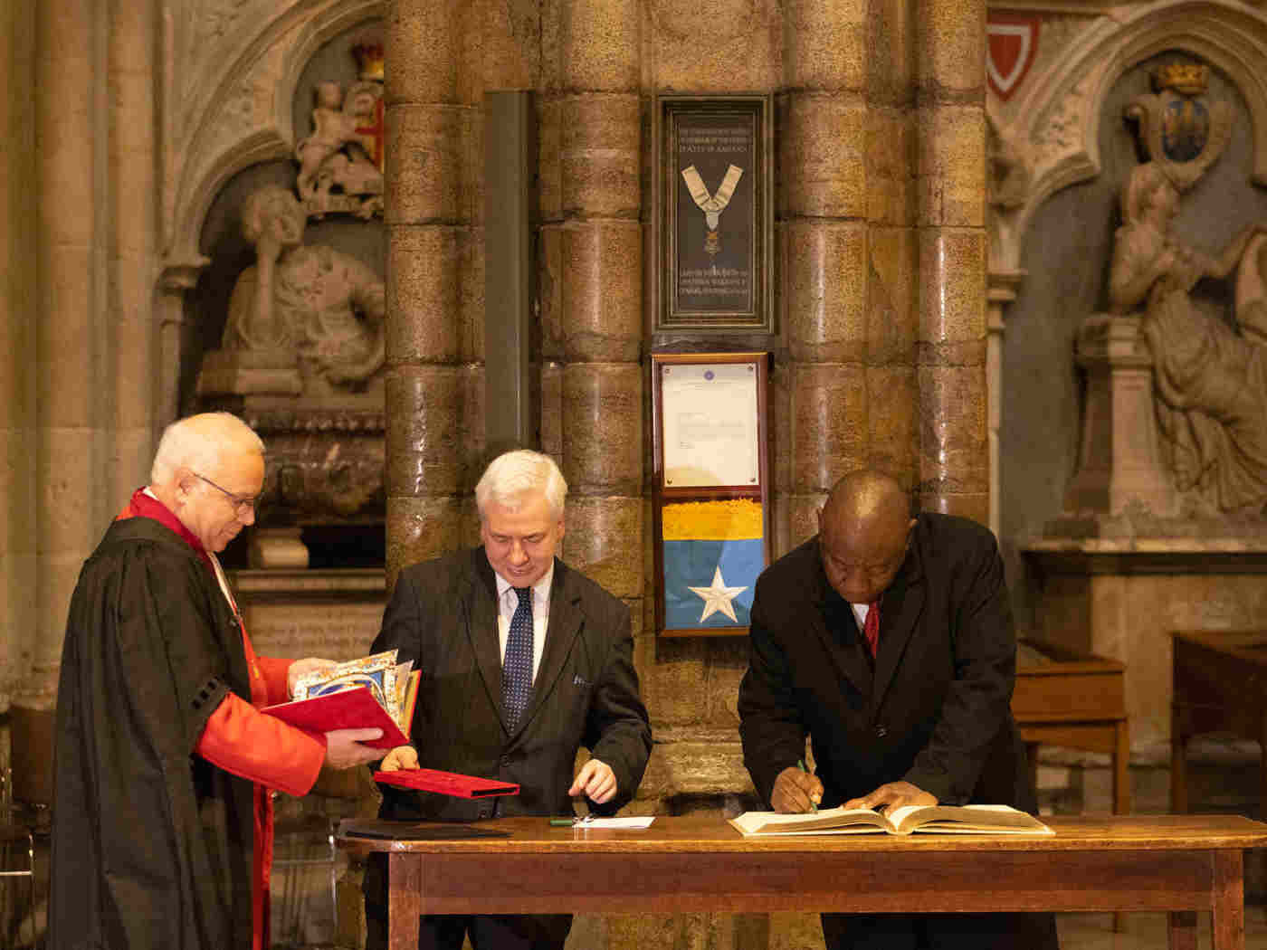The President signs the Distinguished Visitors' book before departing the Abbey