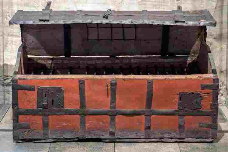 Red wooden chest with locks and ironwork on the exterior