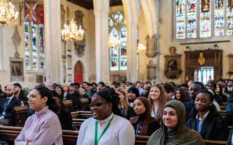 Photograph of students looking engaged seated in St Margaret's Church