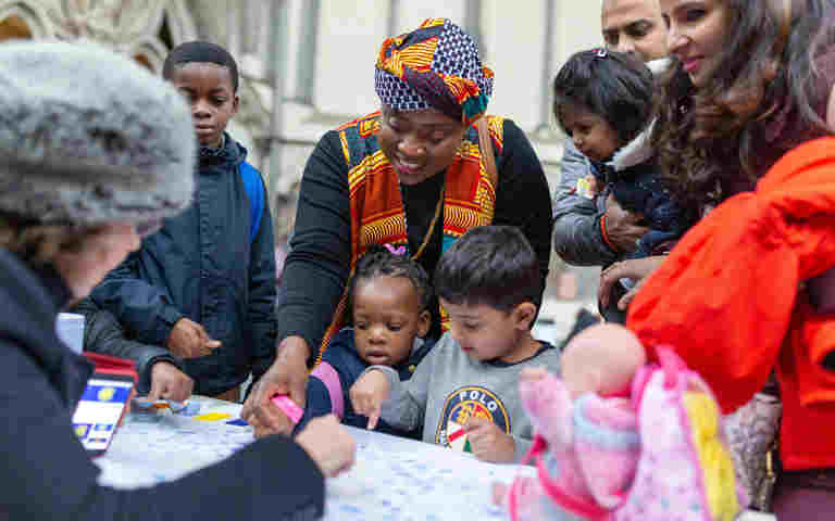 Photograph of adults and children engaging with activities during a family day at Westminster Abbey