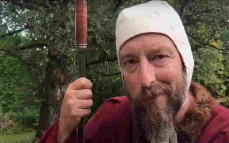 Photograph of Westminster Abbey staff member dressed as a squire for a video about knights