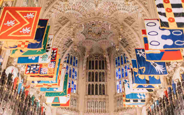 Photograph of the ceiling of the Lady Chapel in Westminster Abbey, featuring a fan-vaulted ceiling and Order of the Bath flags, representing the Tudors trail teachers notes