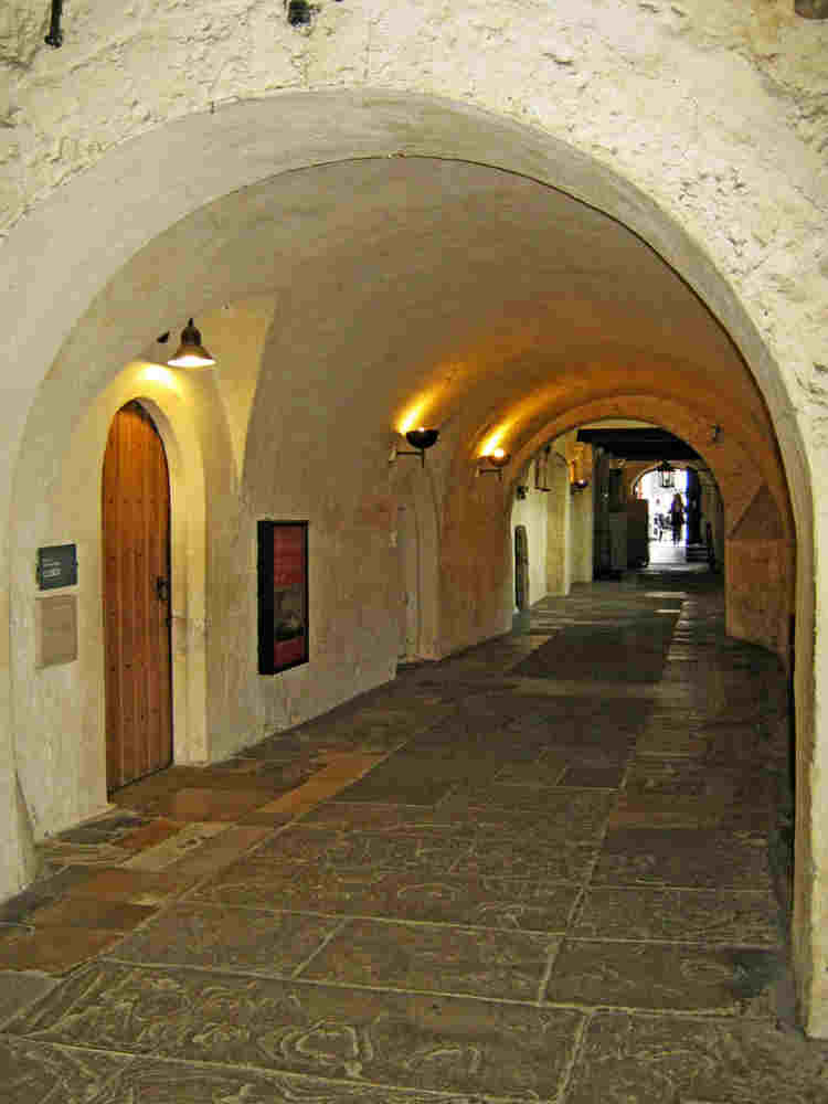 Dark Cloister, Westminster Abbey, a whitewashed arched medieval tunnel with a stone floor