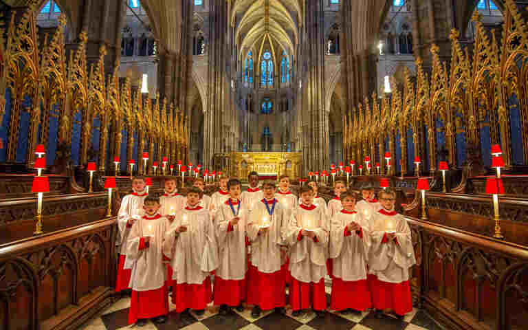 Photograph of choristers standing in the middle of the Quire in Westminster Abbey, representing the Meet the Choristers Abbey at Home video