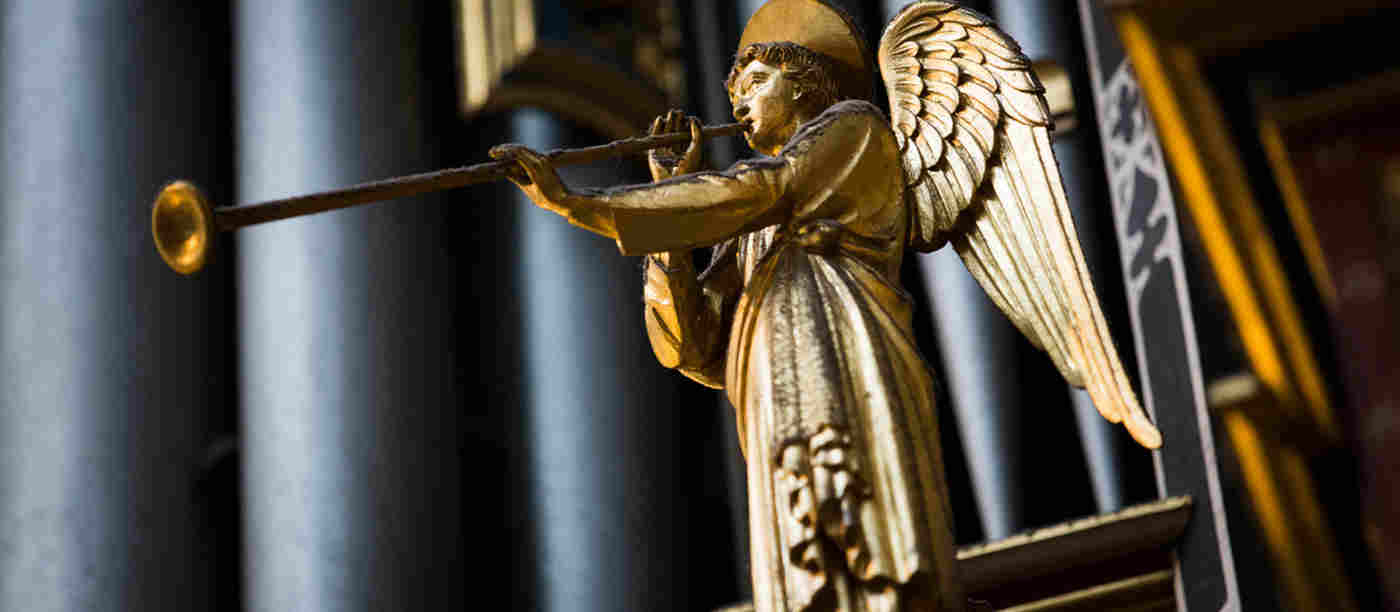 Gold statue of an angel blowing a trumpet, decoration on Westminster Abbey's Harrison & Harrison organ