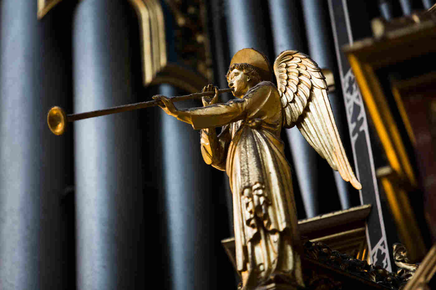 Gold statue of an angel blowing a trumpet, decoration on Westminster Abbey's Harrison & Harrison organ