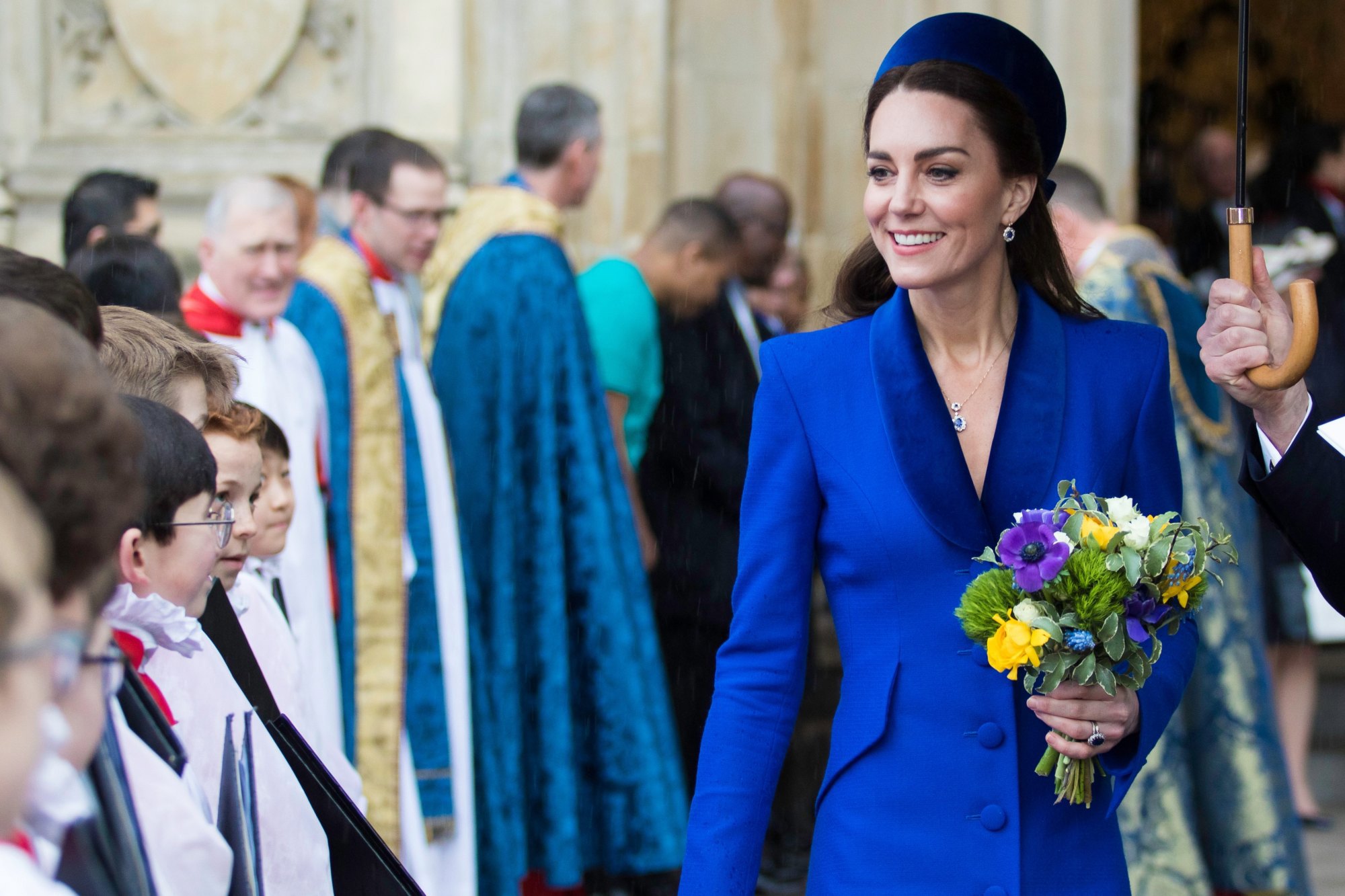 The Princess of Wales smiling as she walks past the Abbey choir