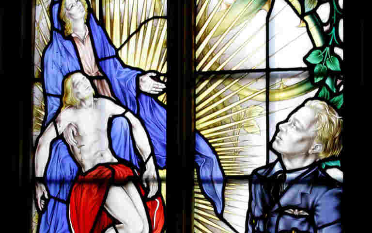 Photograph of a close up of a soldier, Jesus and Mary within the Battle of Britain window within Westminster Abbey, as part of the Remembrance Live schools event