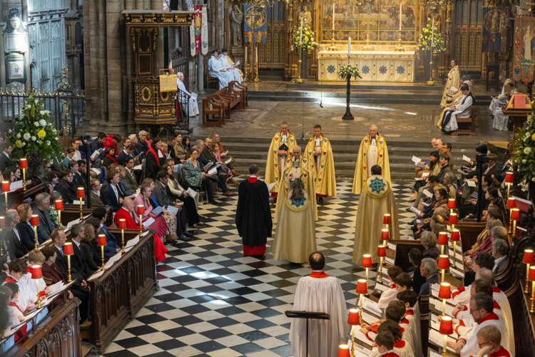 Evensong on Westminster Abbey on Easter Day. Clergy wearing gold copes stand before the congregation who are seated in the quire stalls.