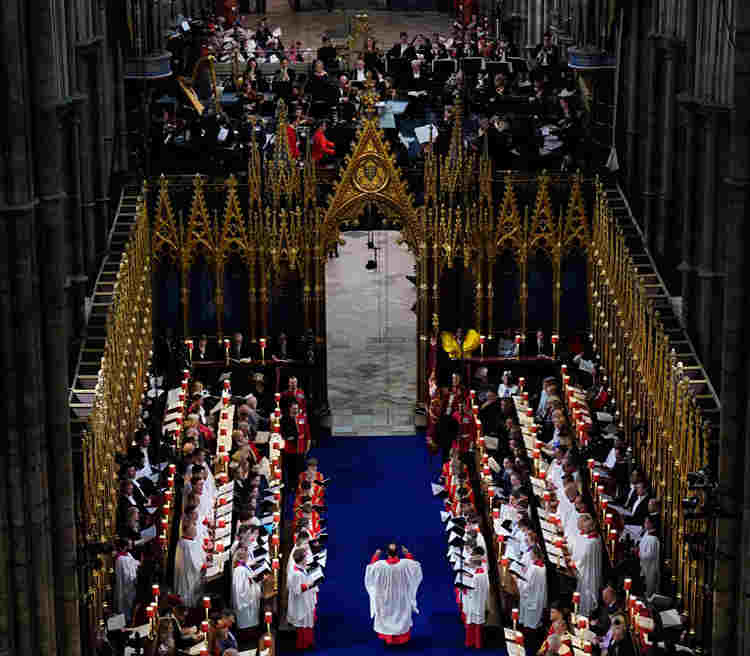Photograph looking down onto the orchestra and choirs who performed at HM King Charles III's coronation, with conductor Andrew Nethsingha in the middle of the image,