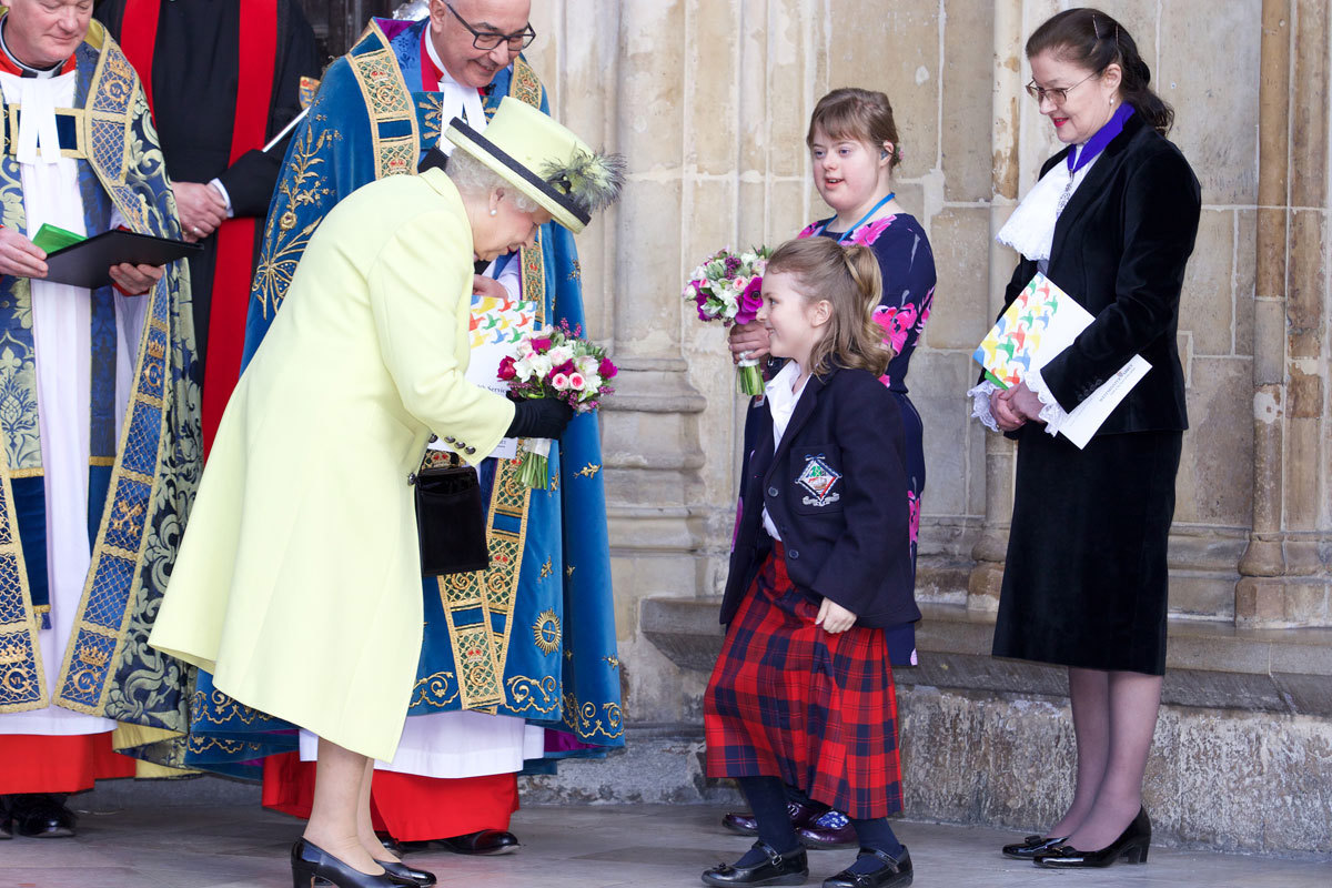 HM The Queen is presented with flowers by Sophie Hall, aged 7